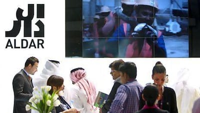 Visitors look at the model of Aldar's Al Zeina project at Cityscape in Abu Dhabi last month. Pawan Singh / The National