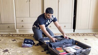 Omar Al Ansari, a 22-year-old Emirati who is studying at the Arizona State University, packs his bag for his final semester. Reem Mohammed / The National