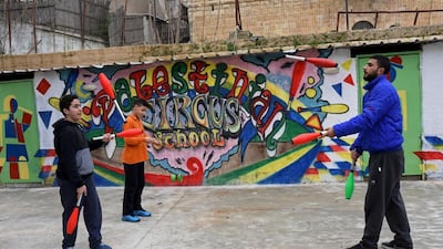 Jareer Taha, 14, left, and Ahamd Abu Taleb, 24, juggle clubs together. The circus pedagogy is to help stimulate and develop the mental, physical, artistic and social abilities of apprentices, while teaching them to resist the occupation in a peaceful manner.