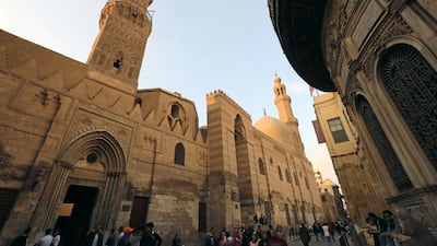 People walk in front of mosques and Islamic schools at El Moez Ledin Allah El Fatmy Street, in old Islamic Cairo. Egypt is implementing a tourism reform programme to boost its tourism competitiveness and align the sector with international standards. Reuters