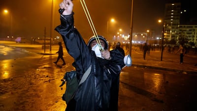 An anti-government demonstrator uses a slingshot against the Lebanese riot police in Beirut. AP Photo