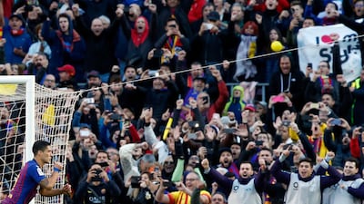 Barcelona forward Luis Suarez celebrates after scoring his side's second goal during the Spanish La Liga soccer match between FC Barcelona and Real Madrid at the Camp Nou stadium in Barcelona, Spain. AP Photo
