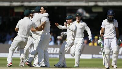 Australia players celebrate taking the wicket of England's Moeen Ali, right, on the fourth day of the second Ashes Test match between England and Australia at Lord's cricket ground in London, Sunday, July 19, 2015. (AP Photo/Kirsty Wigglesworth)