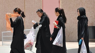 Filipina maids carry shopping bags as they walk out of a mall in Riyadh on June 12, 2013. Fayez Nureldine / AFP Photo