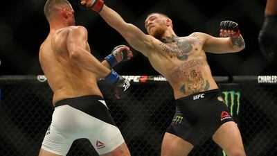 Conor McGregor punches at Nate Diaz during their UFC 196 welterweight bout in Las Vegas on Sunday morning. Rey Del Rio / Getty Images / AFP / March 6, 2016