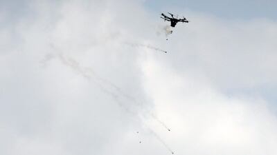 An Israeli drone drops tear gas grenades during clashes with Palestinian protesters. Mahmud Hams / AFP Photo