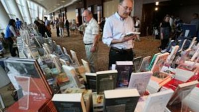 Visitors browsing through books on display in the Emirates Airline International Festival of Literature at Intercontinental hotel in Dubai Festival City, Dubai.