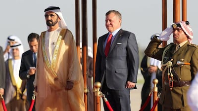 Sheikh Mohammed bin Rashid, Vice President of the UAE and Ruler of Dubai, and Jordan's King Abdullah II listen to their national anthems during a welcome ceremony at Amman's Queen Alia International Airport on March 28, 2017, ahead of talks on the eve of the Arab League summit. Khalil Mazraawi / AFP