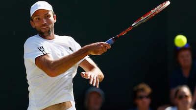 Ivo Karlovic of Croatia plays a forehand in his men's singles third round match against Jo-Wilfried Tsonga of France during Day 6 of the Wimbledon Lawn Tennis Championships at the All England Lawn Tennis and Croquet Club on July 4, 2015 in London, England. Julian Finney / Getty Images