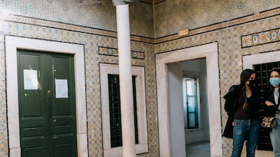 Audience members lie beneath dozens of cracked and damaged screens in Frederich Boell's 'Colours of the Medina', which reveal a rainbow of colours upon closer inspection. Erin Clare Brown / The National