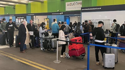Passengers in a long queue for check in outside Terminal 1 at Manchester Airport. Reuters