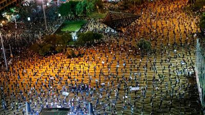 Israelis, keeping at a safe distance from one another, take part in a"Black Flag" demonstration at Rabin Square in the coastal city of Tel Aviv. AFP