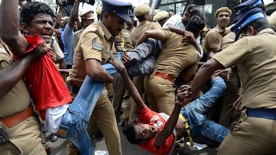 File photo from May 2017 showing Indian police removing members of the Revolutionary Students and Youth Front during a protest the ban on the sale of cows for slaughter in Chennai. India's top court on July 11, 2017 stayed a nationwide ban imposed by the government on the sale of cattle for slaughter that had provoked outcry in many states. Arun Sankar/AFP Photo
