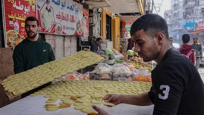 Palestinians prepare traditional 'Qatayef' sweets. AFP