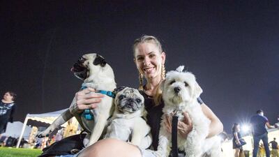 A proud pet owner with her three adorable dogs.