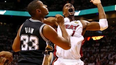 Chris Bosh, right, of the Miami Heat goes to the basket against Boris Diaw of the San Antonio Spurs during Game Four of the 2014 NBA Finals at American Airlines Arena on June 12, 2014 in Miami, Florida. Andy Lyons/Getty Images