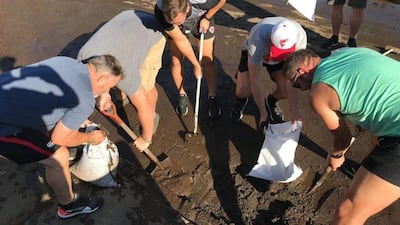 Handout photo taken with permission from the Twitter feed of members of the Canadian rugby team, whose match against Namibia was cancelled, helping to clear roads after typhoon Hagibis saw torrential rain and tornado-like winds hit large parts of Japan. PA Photo.