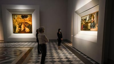 Journalists admire 15th century paintings 'Annunciation', right, and 'Adoration of the Magi' by Leonardo Da Vinci. AP Photo