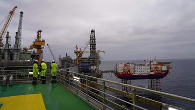 Journalists and employees of Norwegian oil producer Equinor look out at the platforms producing oil above the Johan Sverdrup oilfield during a media visit, in the North Sea. Fifty years after the Scandinavian country first struck black gold, the field holds the promise of another half-century of oil business, despite growing opposition to fossil fuels. AFP