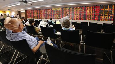 THAILAND - Investors monitor share prices data displayed on electronic boards at a stock brokerage in Bangkok. The Stock Exchange of Thailand main index was down 15.14 points in late Monday trade. Rungroj Yongrit / EPA