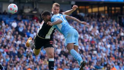 Manchester City's Raheem Sterling, right, heads the ball to score his side's first goal during the English Premier League soccer match between Manchester City and Newcastle United at Etihad stadium in Manchester, England, Sunday, May 8, 2022. (AP Photo / Jon Super)