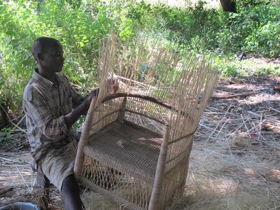 A worker weaves a chair in Malawi, part of a fair-trade project that has benefitted more than 600 village people there. Courtesy Tribe