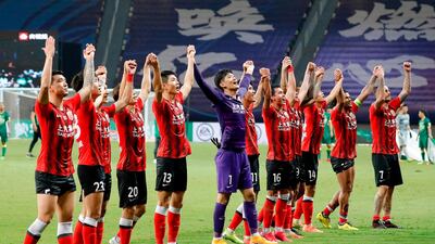 Shanghai SIPG players celebrate in front of fans after their Chinese Super League win over Beijing Guoan in Suzhou on Saturday. AFP