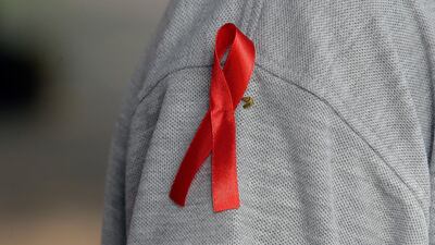The red ribbon, an international symbol of HIV/Aids, is worn to raise the awareness in the fight against HIV infection. EPA