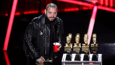 Post Malone accepts awards onstage at the Billboard Music Awards. Reuters