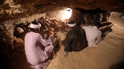 Egyptian archaeologists work inside a recently discovered tomb at the Draa Abul Nagaa necropolis in Luxor's West Bank in Egypt. Khaled Elfiqi / EPA