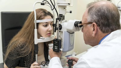 Dr.Jeffrey Weiss, who is studying bone marrow fraction therapy to restore vision for people who have no other treatment options, examined Dana Nashawati, who suffers from Optic Nerve Atrophy. Antonie Robertson / The National