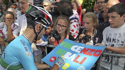 Vincenzo Nibali, otherwise known as the Shark of Messina, signs an autograph for young cycling fans on Monday. Stefano Rellandini / Reuters