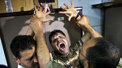 Iraqi volunteers from the Yazidi sect learn how to handle a weapon during a training camp at the Serimli military base, which is controlled by the Kurdish People’s Protection Units (YPG), in Qamishli, northeastern Syria on the border with Kurdistan. Youssef Boudlal / Reuters
