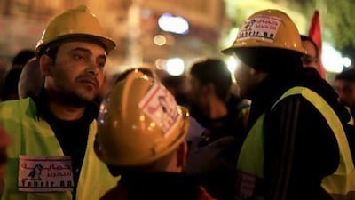 Egyptian volunteers of Tahrir Bodyguard, an anti-harassment group, work at a rally in Tahrir Square, Cairo.