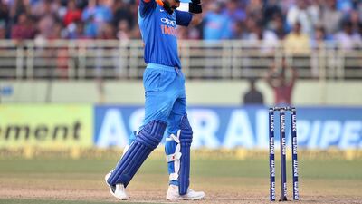 India's captain Virat Kohli celebrates scoring 10,000 runs in one-day internationals during the second one-day international cricket match between India and West Indies in Visakhapatnam, India, Wednesday, Oct. 24, 2018. (AP Photo/Aijaz Rahi)
