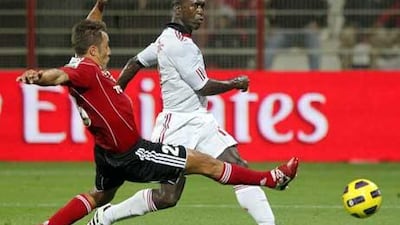 AC Milan's Clarence Seedorf, right, vies with Fabio Cannavaro of Al Ahli club during their Emirates Challenge Cup match in Dubai.