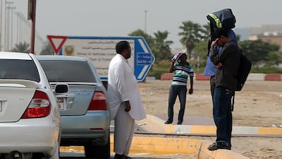 An illegal cab driver waits for customers outside the Emirates Driving Company in Mussaffah, Abu Dhabi. Satish Kumar / The National