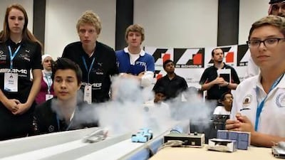 Julian Beyerlein of Safire, second left, and Timur Becent of Avitus, right, race in the F1 in Schools national championship. Safire have to wait to see if they have won their second consecutive title. Fatima Al Marzooqi / The National