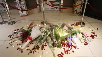 People lay flowers and lit candles near to where Ibolya Ryan was killed in the ladies toilets. Sarah Dea / The National
