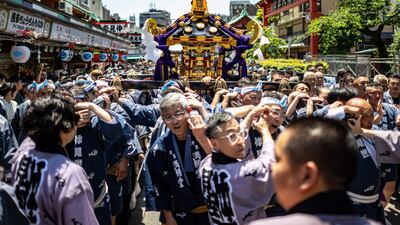 Participants carry a portable shrine on the second day of the annual Sanja Matsuri festival, in the Asakusa district of Tokyo. AFP