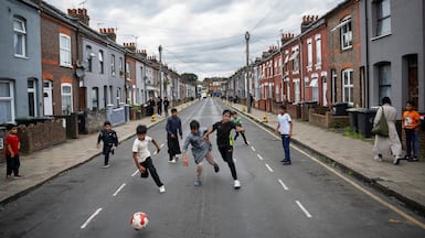 People playing football in the street in Luton, one of the UK towns undergoing rapid change as a result of migration. Getty Images