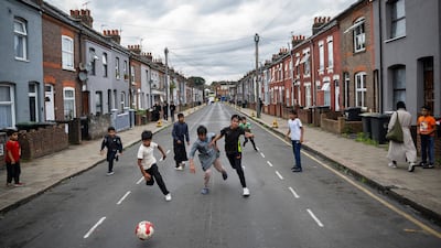 People playing football in the street in Luton, one of the UK towns undergoing rapid change as a result of migration. Getty Images