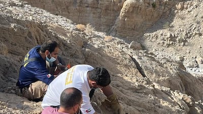 Civil defence crew members provide first aid for a German man injured during a hike. Photo: RAK Civil Defence