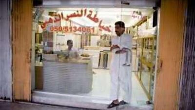 Stitch in time: A man leaves a tailoring shop in the Omani town of Buraimi along the border with UAE near Al Ain.