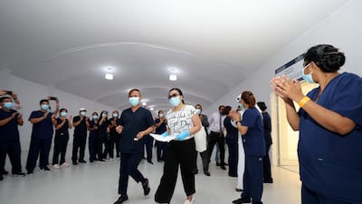 Cheers from medical staff as Dubai Parks and Resorts field hospital discharges its final 17 coronavirus patients before closing. Chris Whiteoak / The National