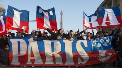 Paris Saint-Germain (PSG) fans SG fans celebrate on the trocadero square after their team clinched a fourth consecutive Ligue 1 crown on March 13, 2016. AFP / Geoffroy Van der Hasselt