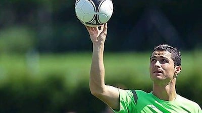Cristiano Ronaldo, left, could emerge from the shadow of Lionel Messi as his generation's best player if Portugal lift the Euro 2012 trophy. Francisco Leong / AFP