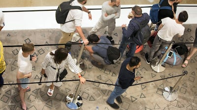 People wait in a queue to purchase the new iPhone XS at the Apple store in Dubai Mall, 12 hours before it goes on sale. Leslie Pableo / The National