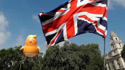 Demonstrators float the blimp next to a Union Flag above Parliament Square. Reuters