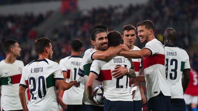 Diogo Jota celebrates with teammates after scoring Portugal's fourth goal. EPA